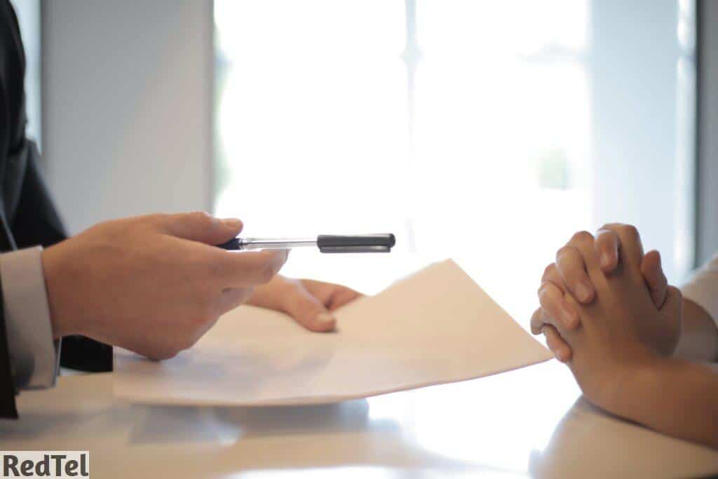 Crop businessman giving contract to woman to sign